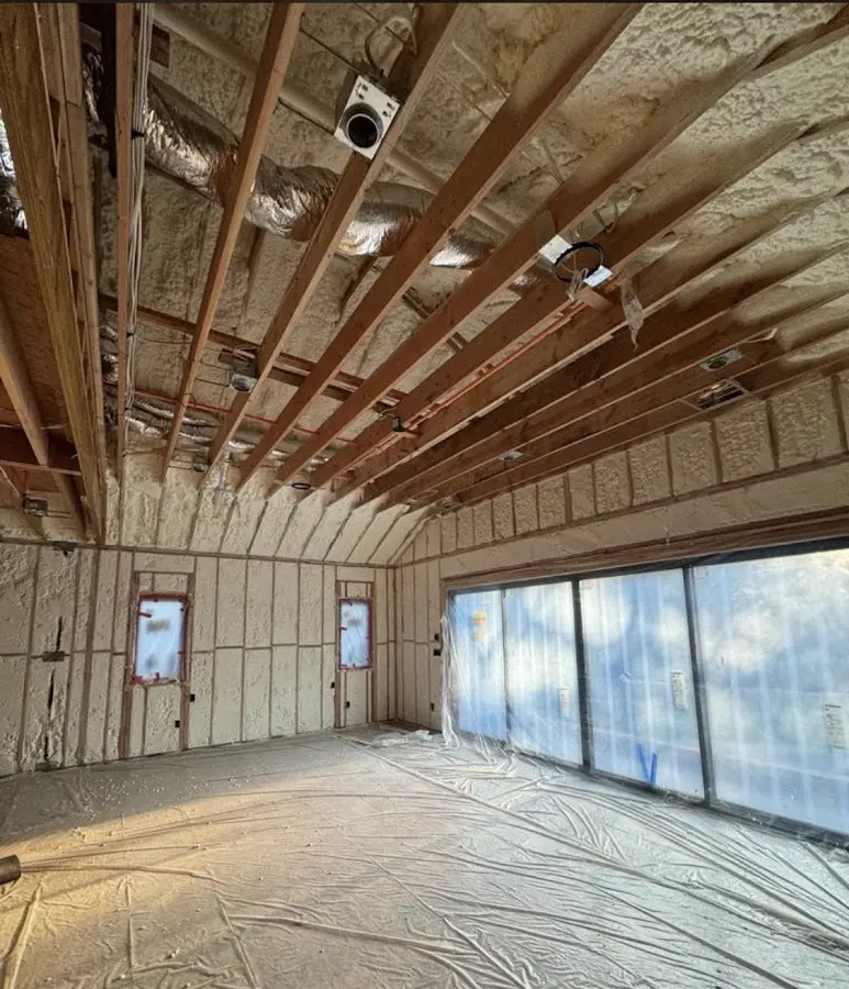 Interior walls and ceiling insulated with spray foam during new construction in Naples Manor